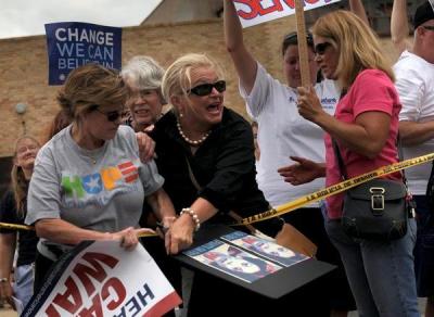 Democrat thug assaults peaceful protester as she calls for help from the police