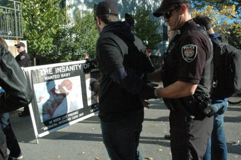 Armed policeman arrests peaceful pro-life student