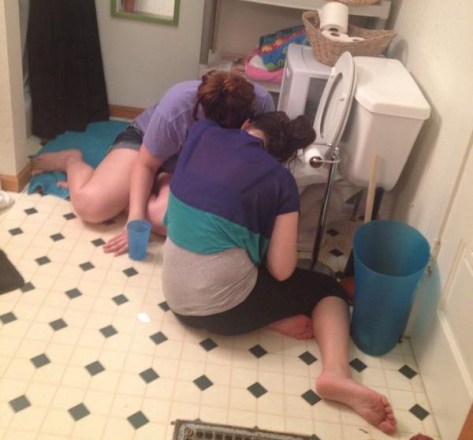 College students puking in toilet