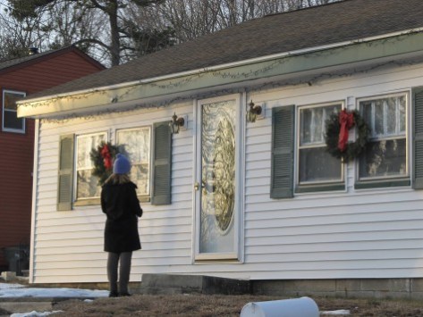 Heidi Cruz waits for a New Hampshire voter to answer the door