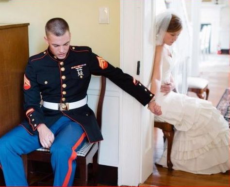 Marine prays with his wife on their wedding day