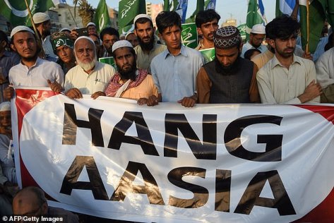 The sign the Pakistani men are holding should read "Hang Asia"